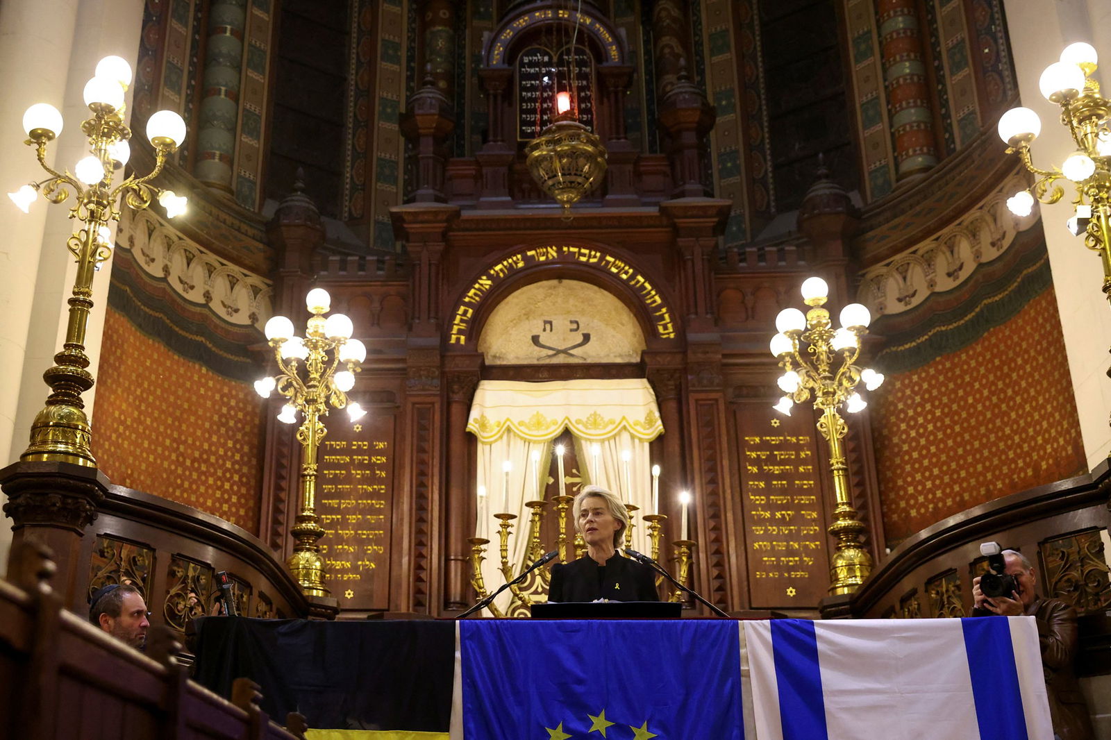 A woman speaking inside a Synagogue. 