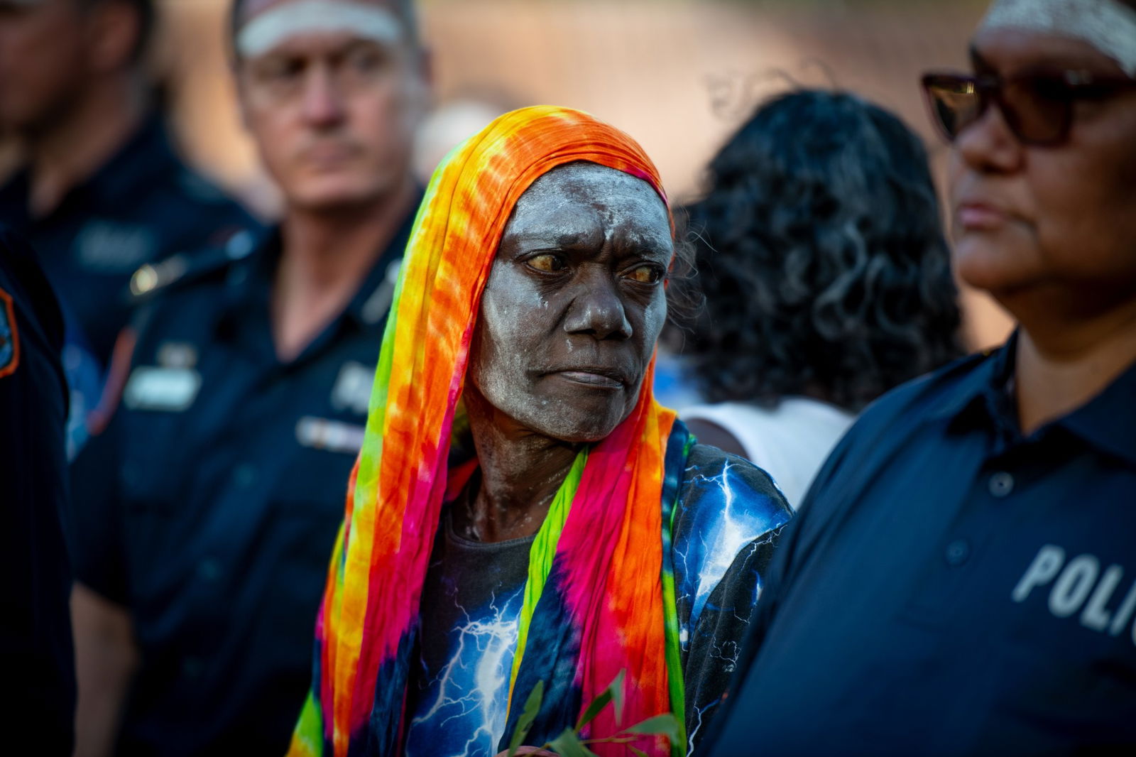 An Indigenous woman with a colourful scarf on her head