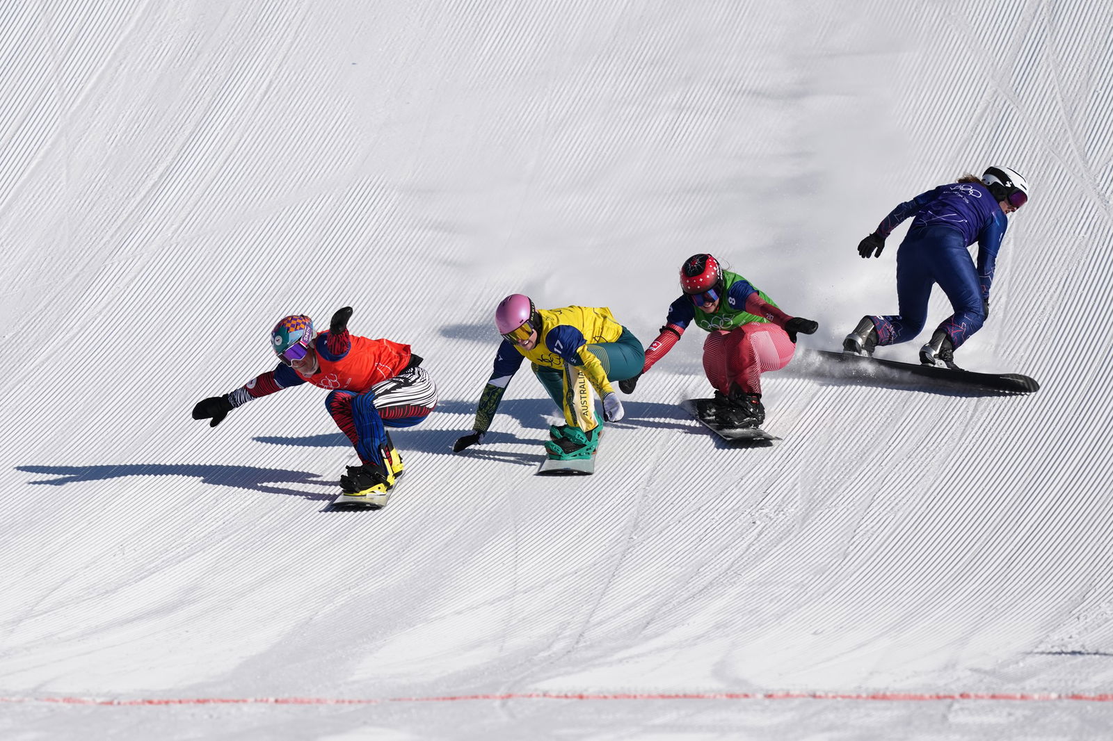 Competitors in the women's snowboard cross quarterfinals.
