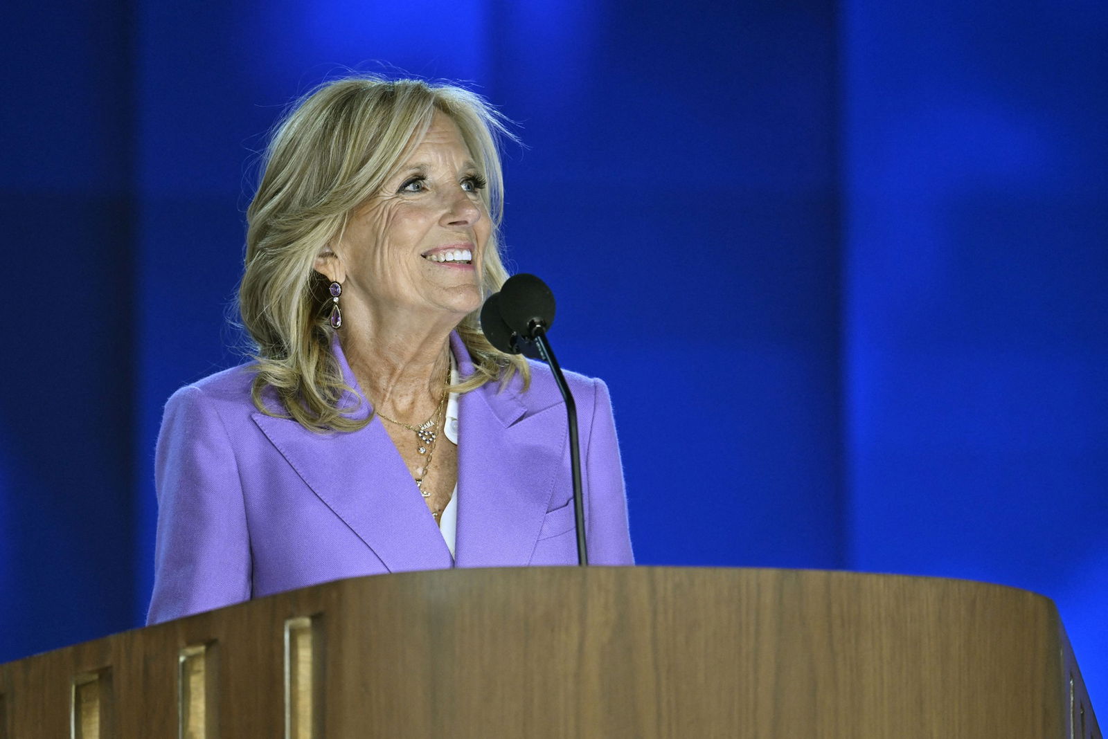 Jilll Biden smiles at a podium.