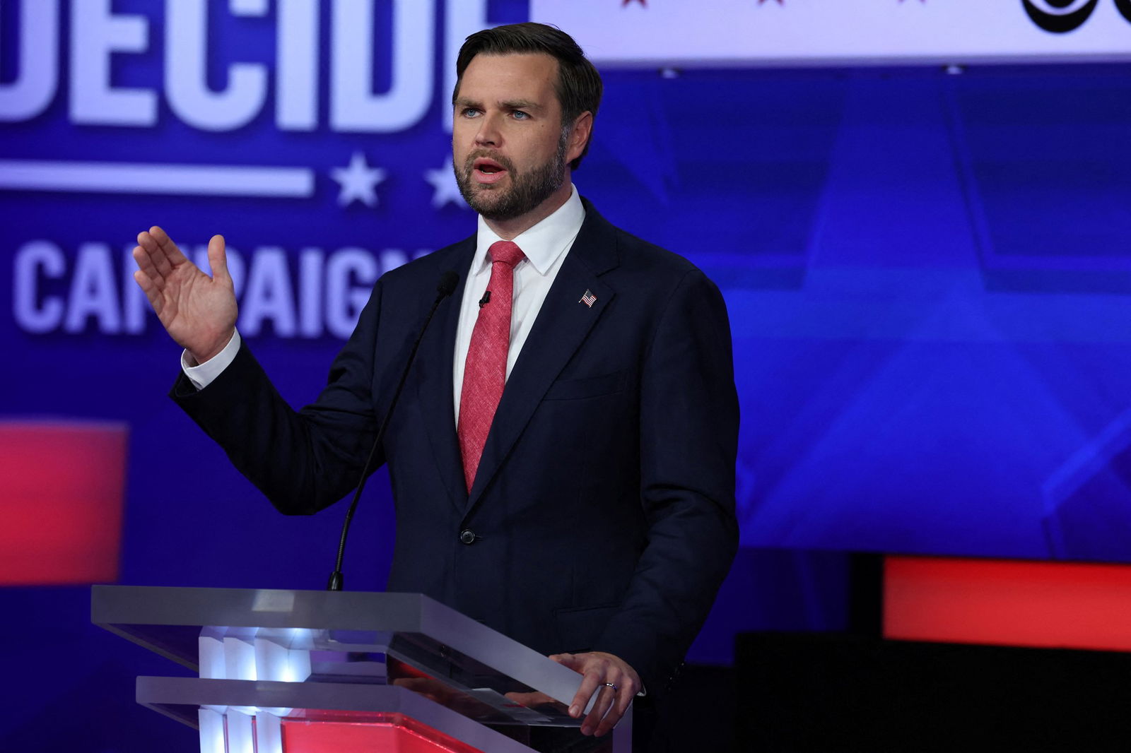 JD Vance wearing a suit, makes a point