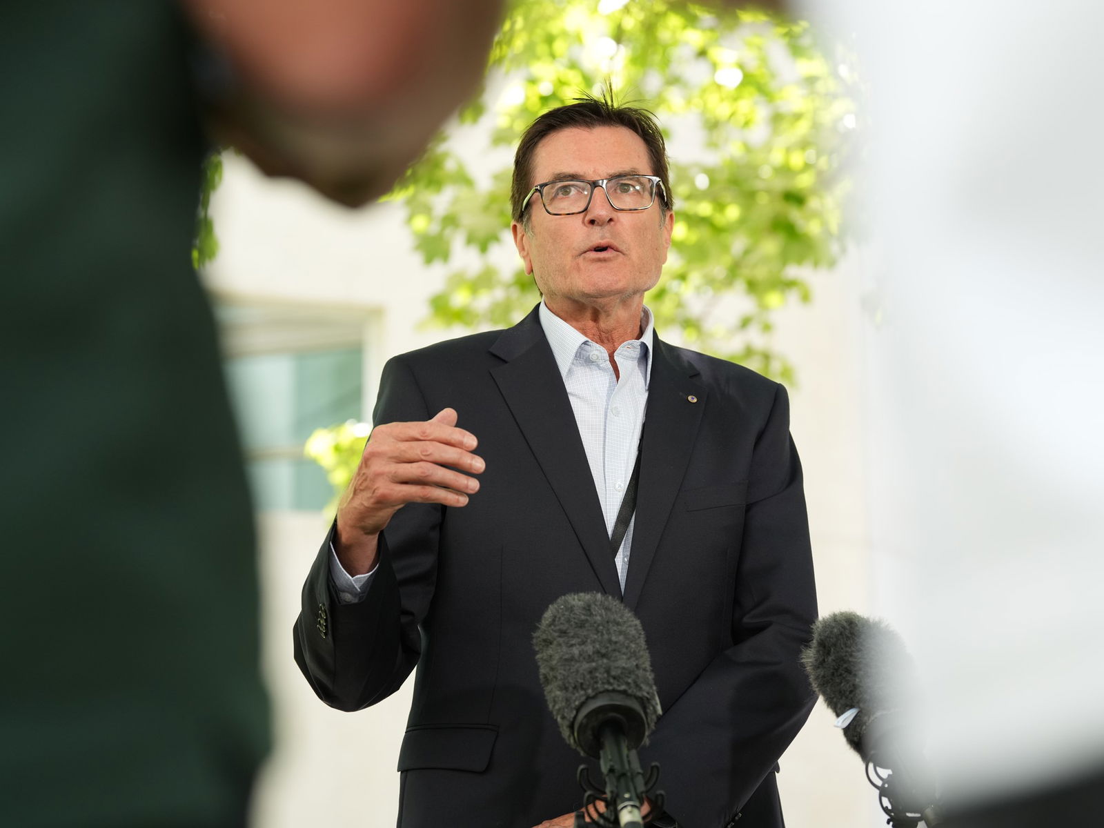 Man stands in front of microphones