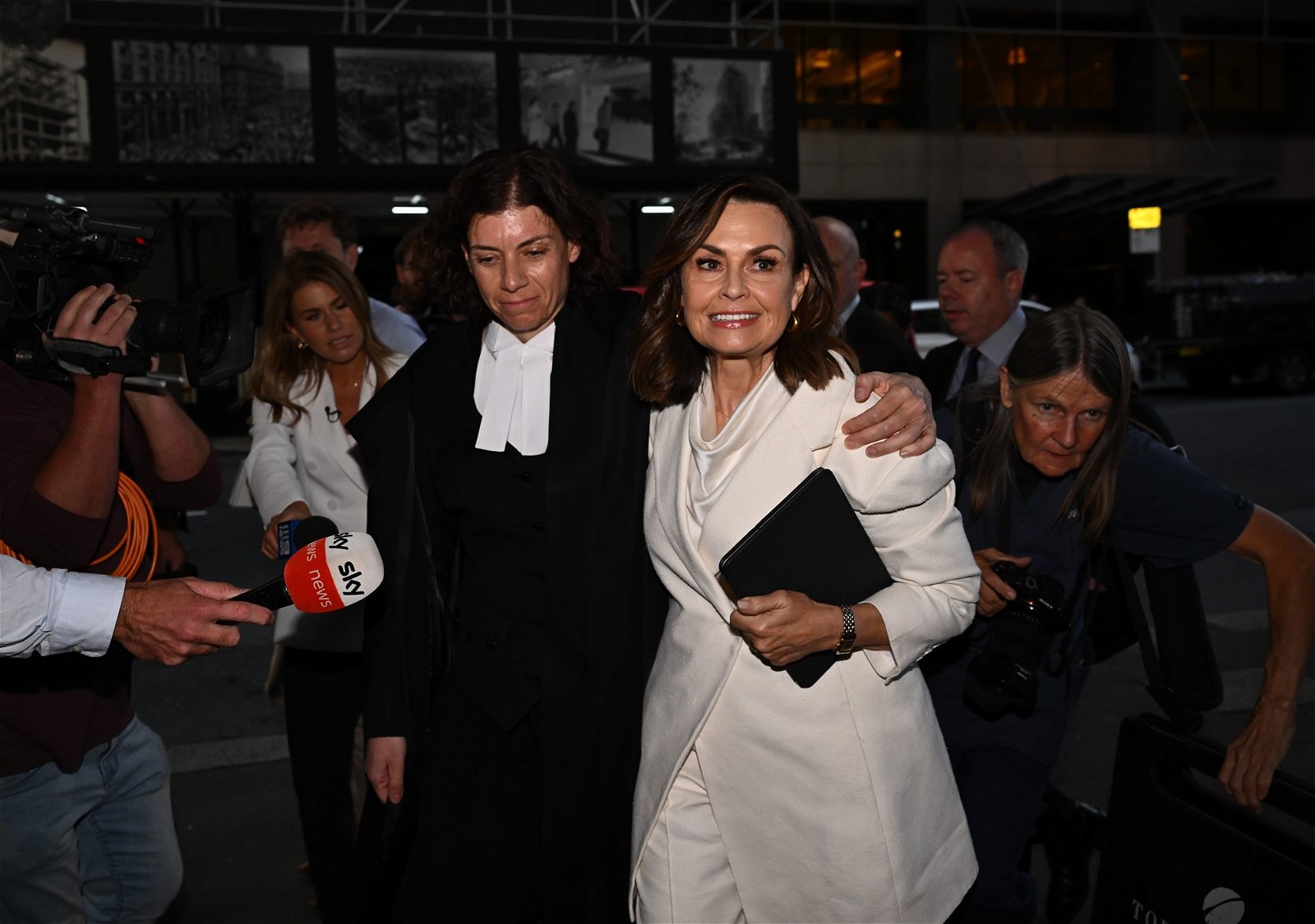 Lisa Wilkinson leaves court with lawyer.