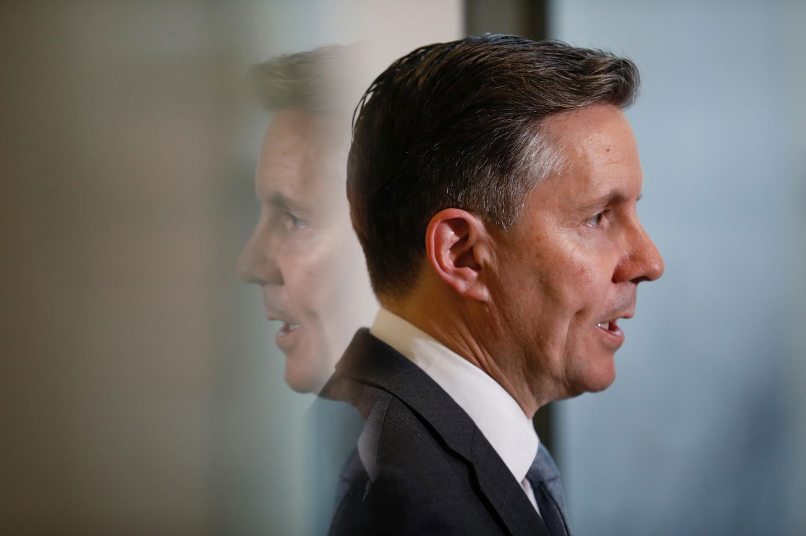 A side profile of a man in a suit