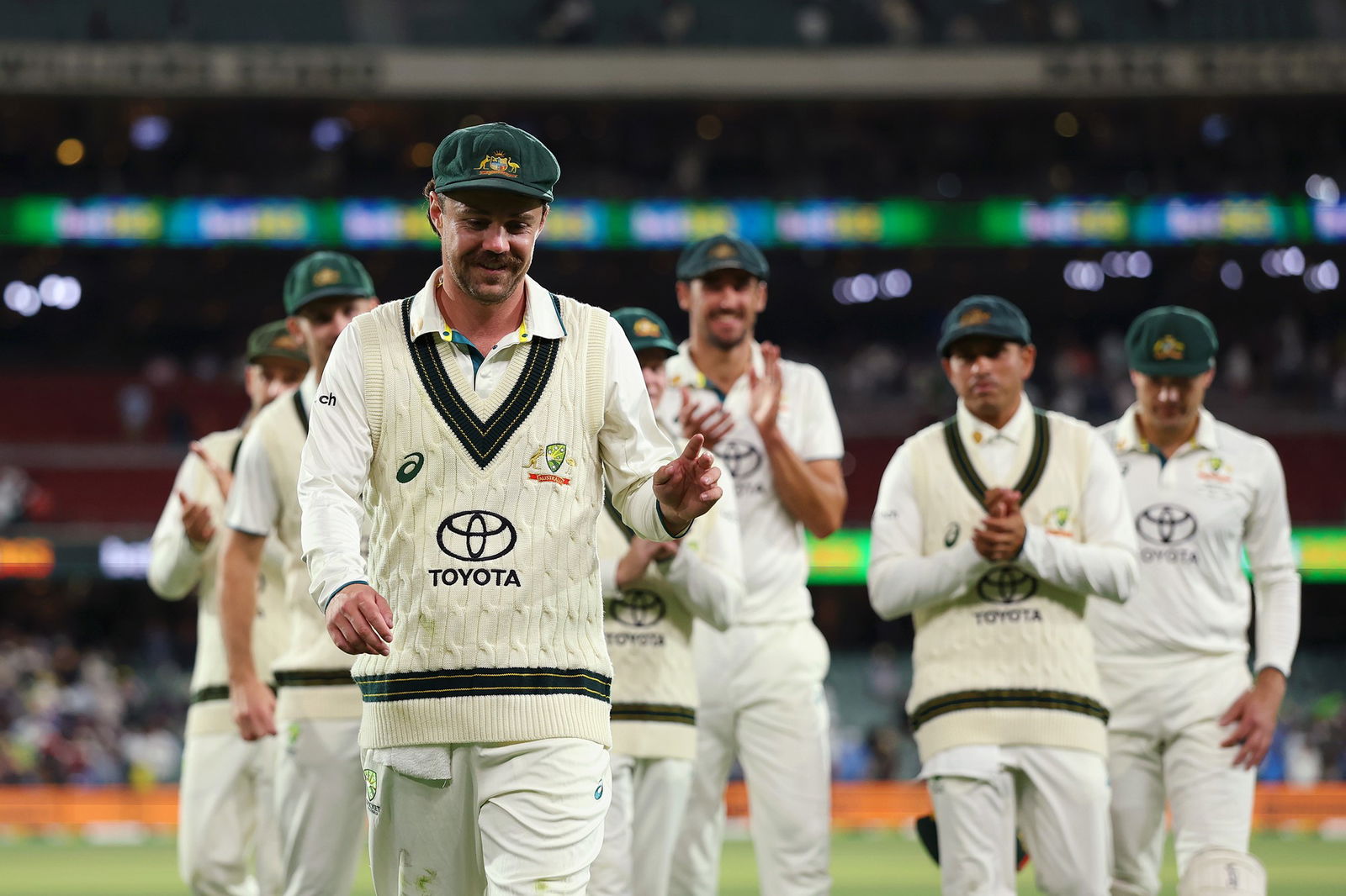 Travis Head leads Australia off the ground after his starring role with the bat on day two.