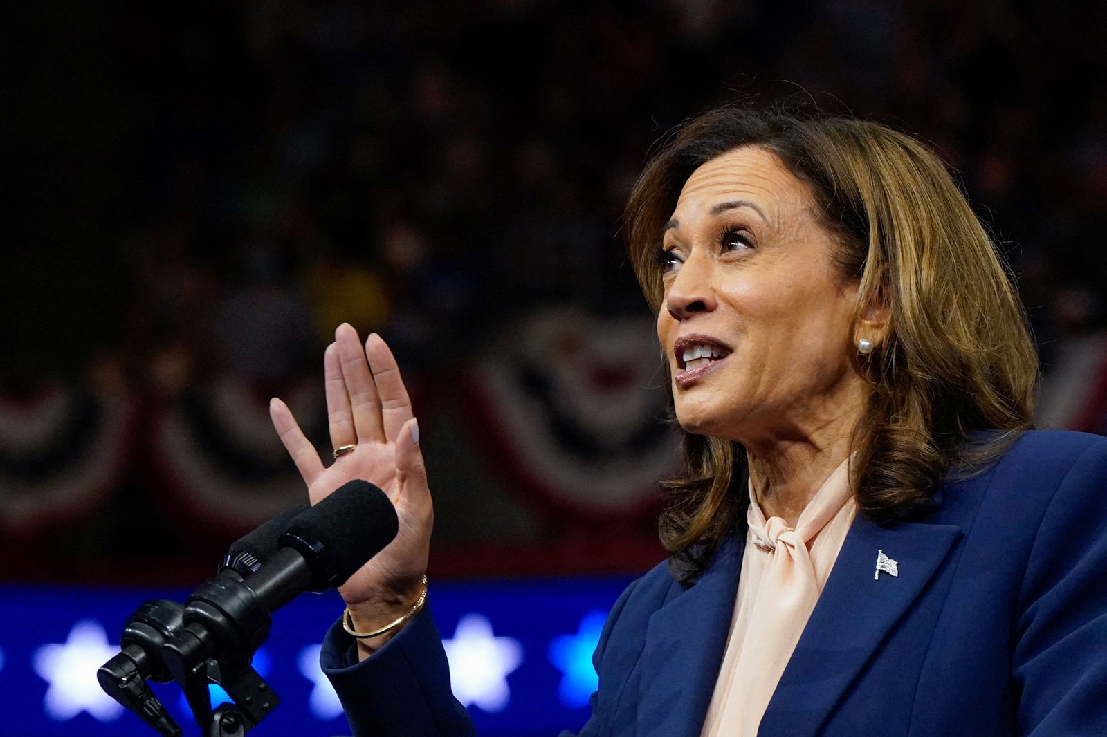 Kamala Harris speaking into a microphone.