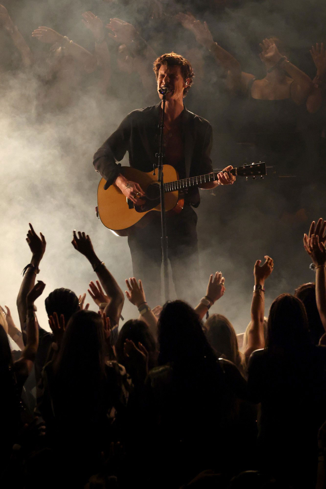 Shawn Mendes on stage with a guitar 