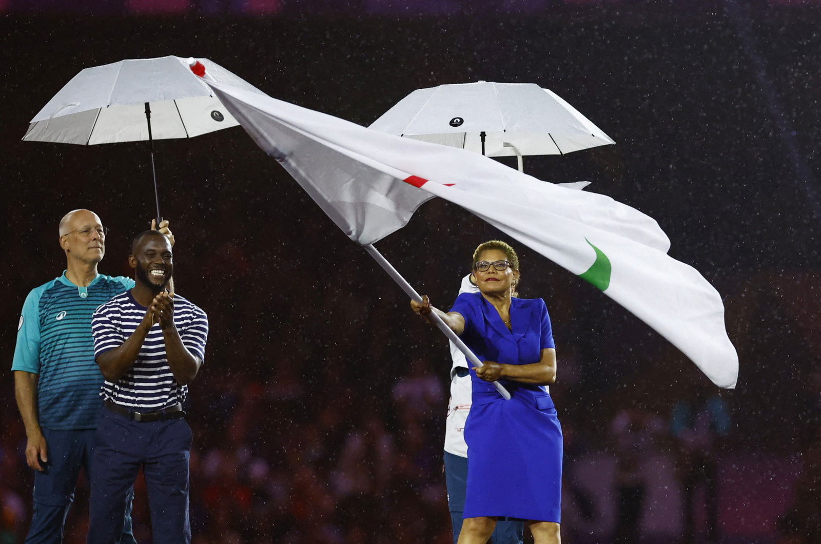 Karen Bass waiving the Paralympic flag  at the Stade de France