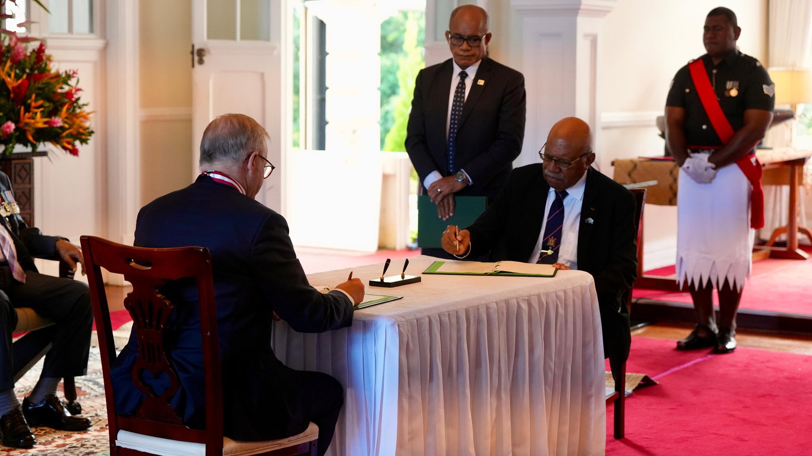 Albanese and Rabuka sign agreements.
