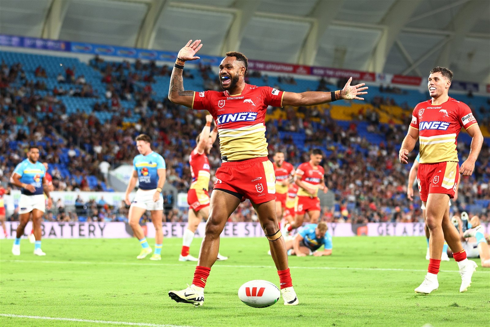 Hamiso Tabuai-Fidow of the Dolphins celebrates a try against the Titans.