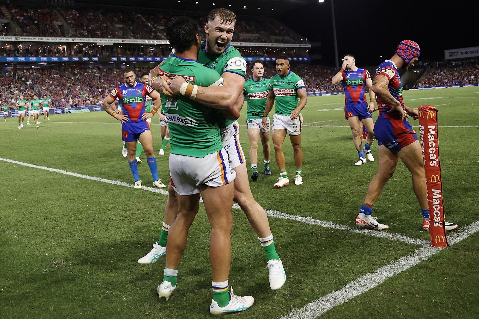 Hudson Young hugs Jordan Rapana after a try against the Newcastle Knights.