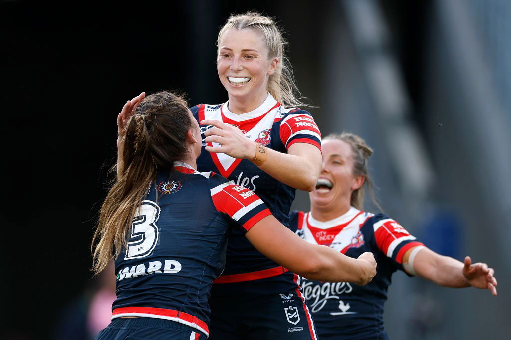 Tarryn Aiken is hugged by Roosters teammates in the NRLW grand final.