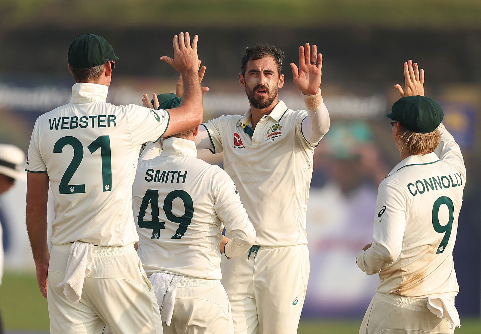 Mitchell Starc high fives Australian Test teammates.