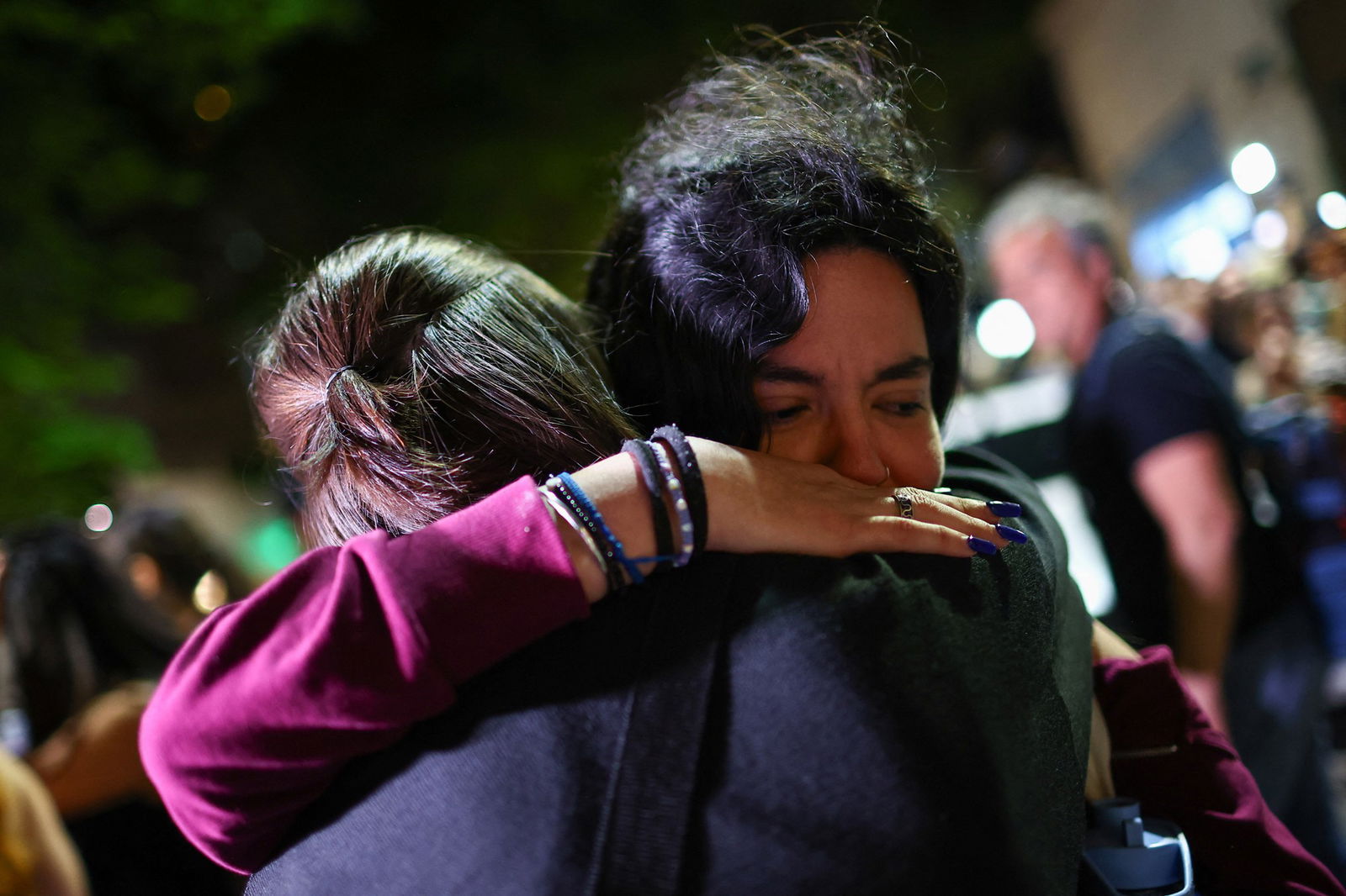 Young fans hug each other