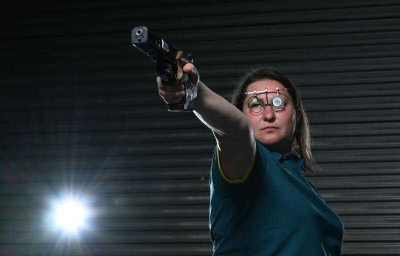 Elena Galiabovitch poses for a photo with her competition pistol