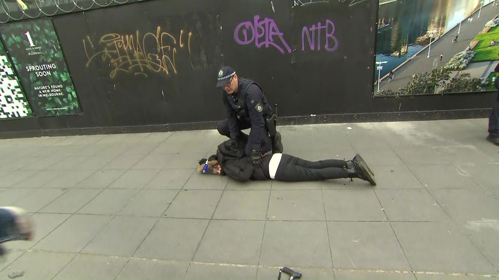 A police officer detaining a protesters