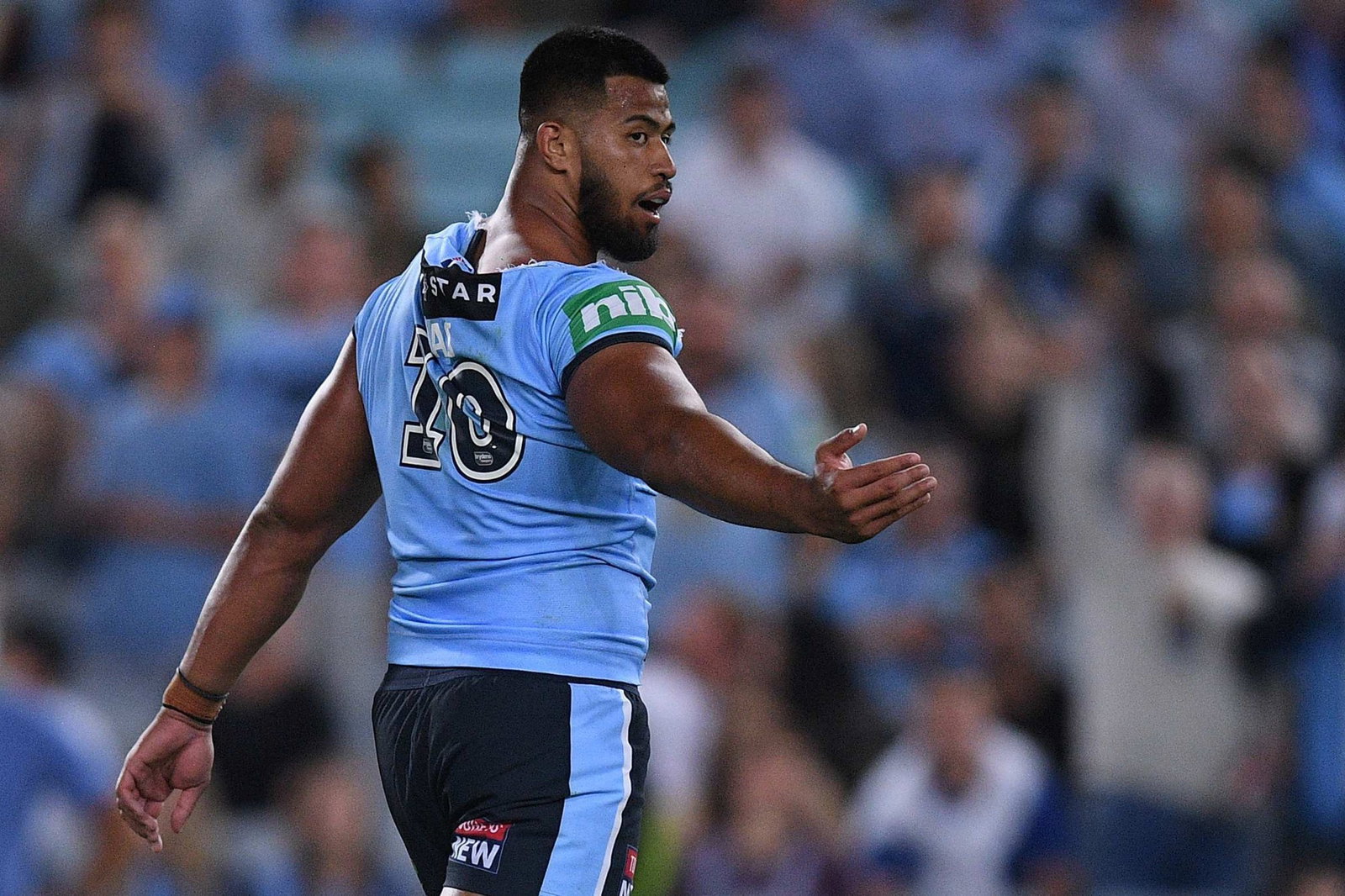 NSW Blues prop Payne Haas gestures behind him after a fight in State Of Origin.