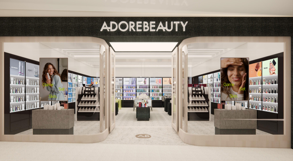 A retail store selling beauty products, with two curved glass windows and a large opening in the centre.