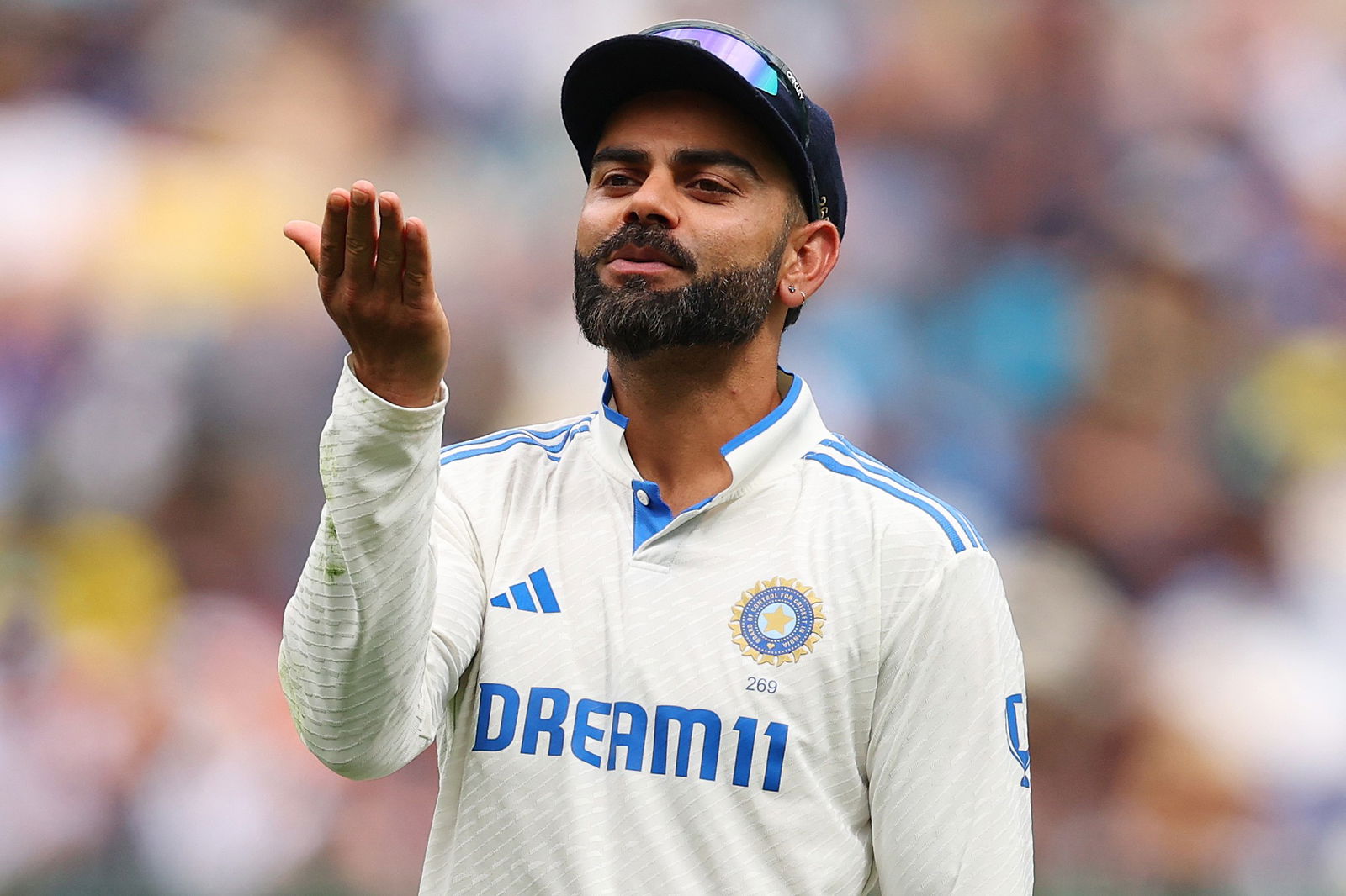 Virat Kohli blows a kiss to the crowd.