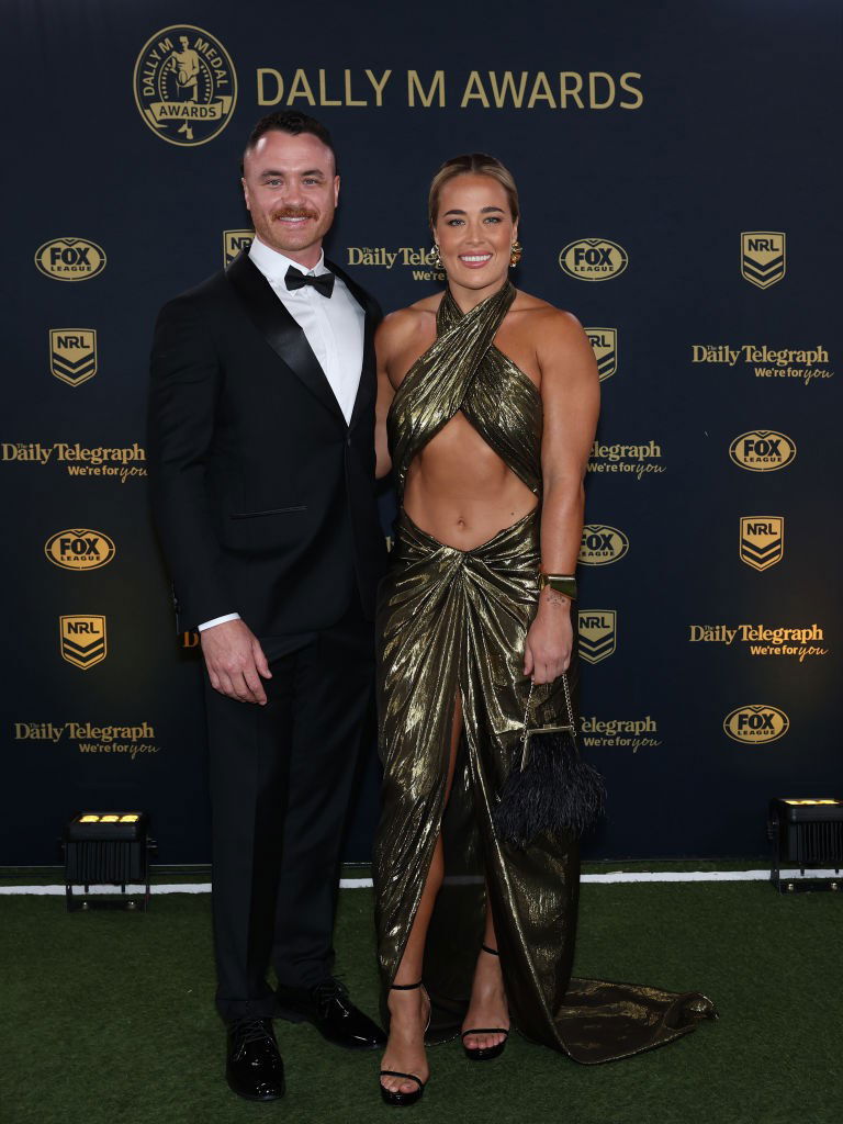 Isabelle Kelly with her partner stands on the Dally M Awards red carpet.