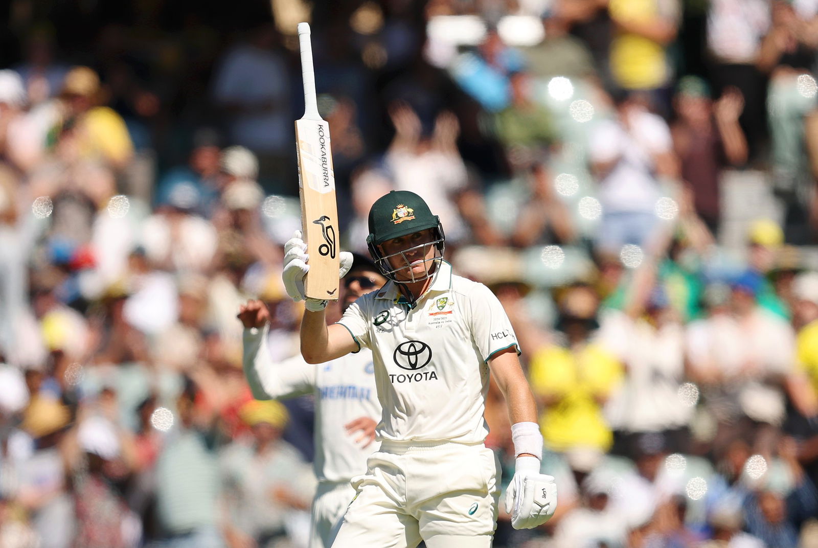 Marnus Labuschagne raises his bat after reaching 50 on day two.