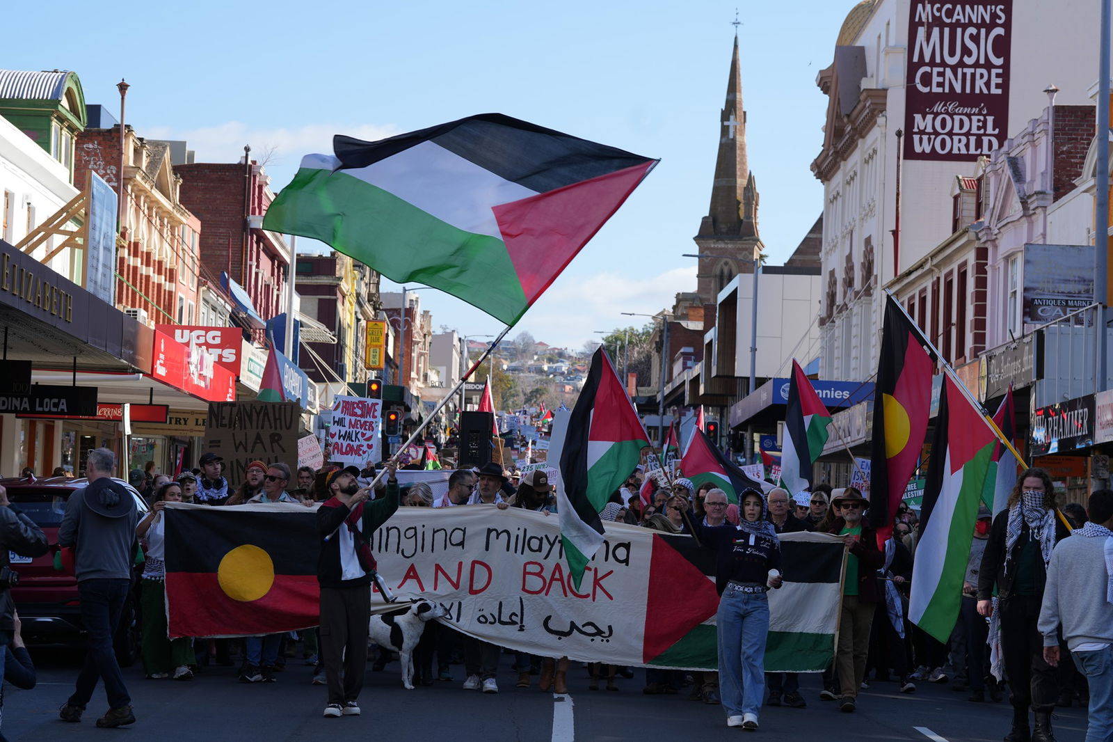 Protesta gājiens Elizabetes ielā Hobārta ar cilvēkiem, kas tur palestīniešu un aborigēnu karogus.