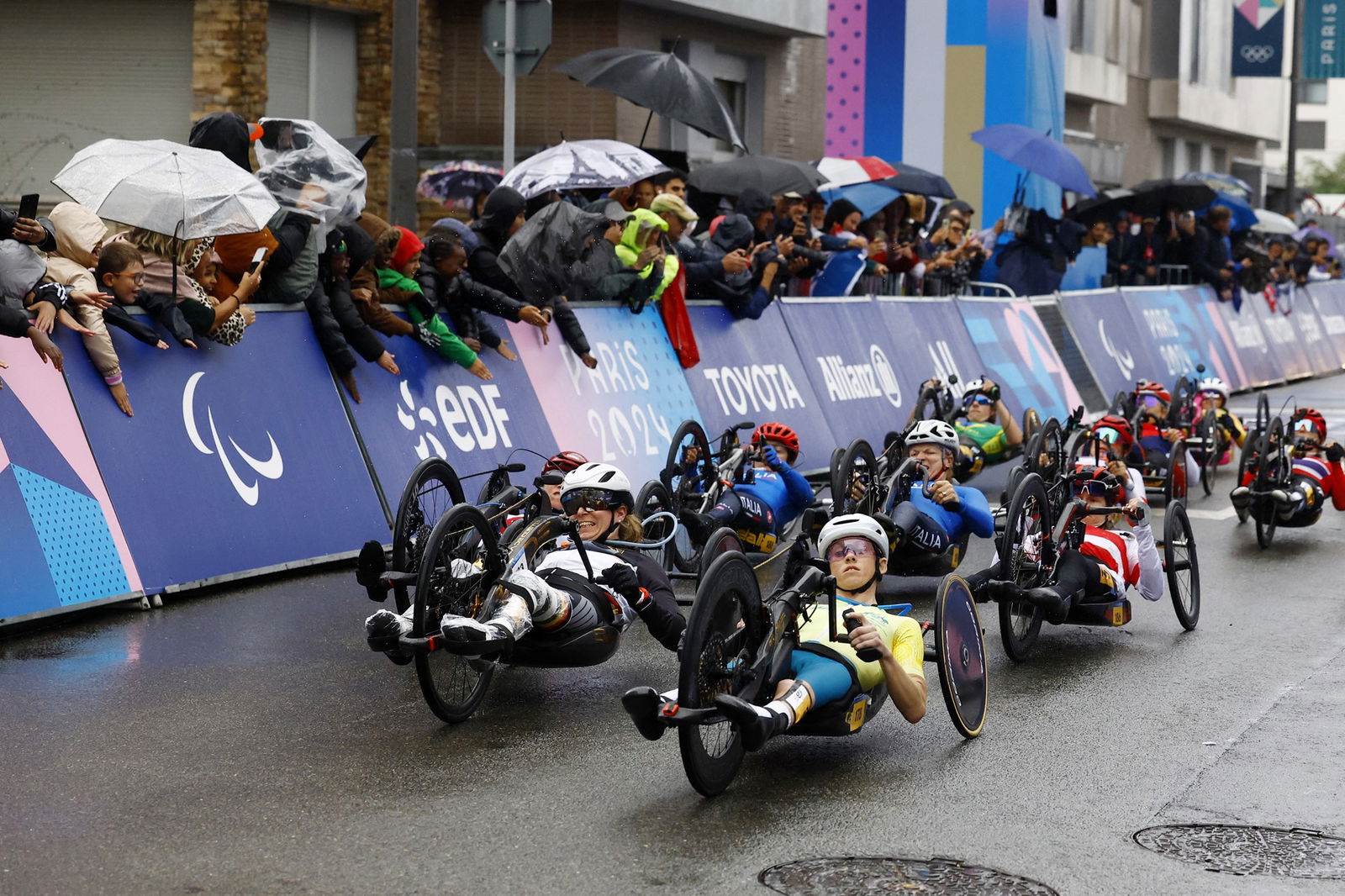 A large group of Paralympic hand cyclists start the road race.