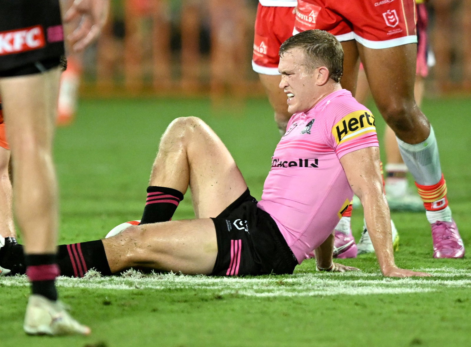 Mitch Kenny of the Panthers sitting on the ground with an injured leg