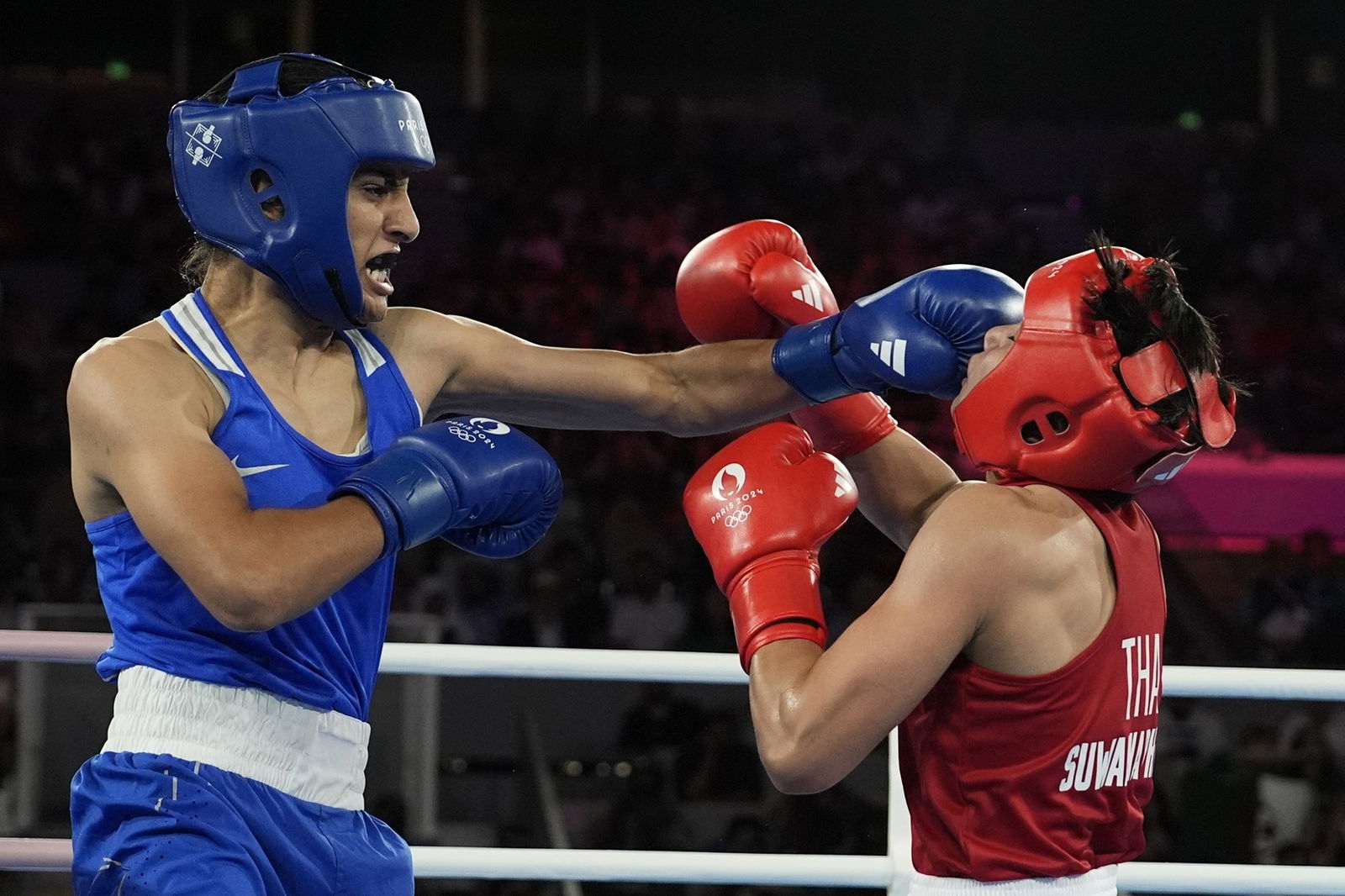 Imane Khelif of Algeria lands a punch against Thailand's Janjaem Suwannapheng.