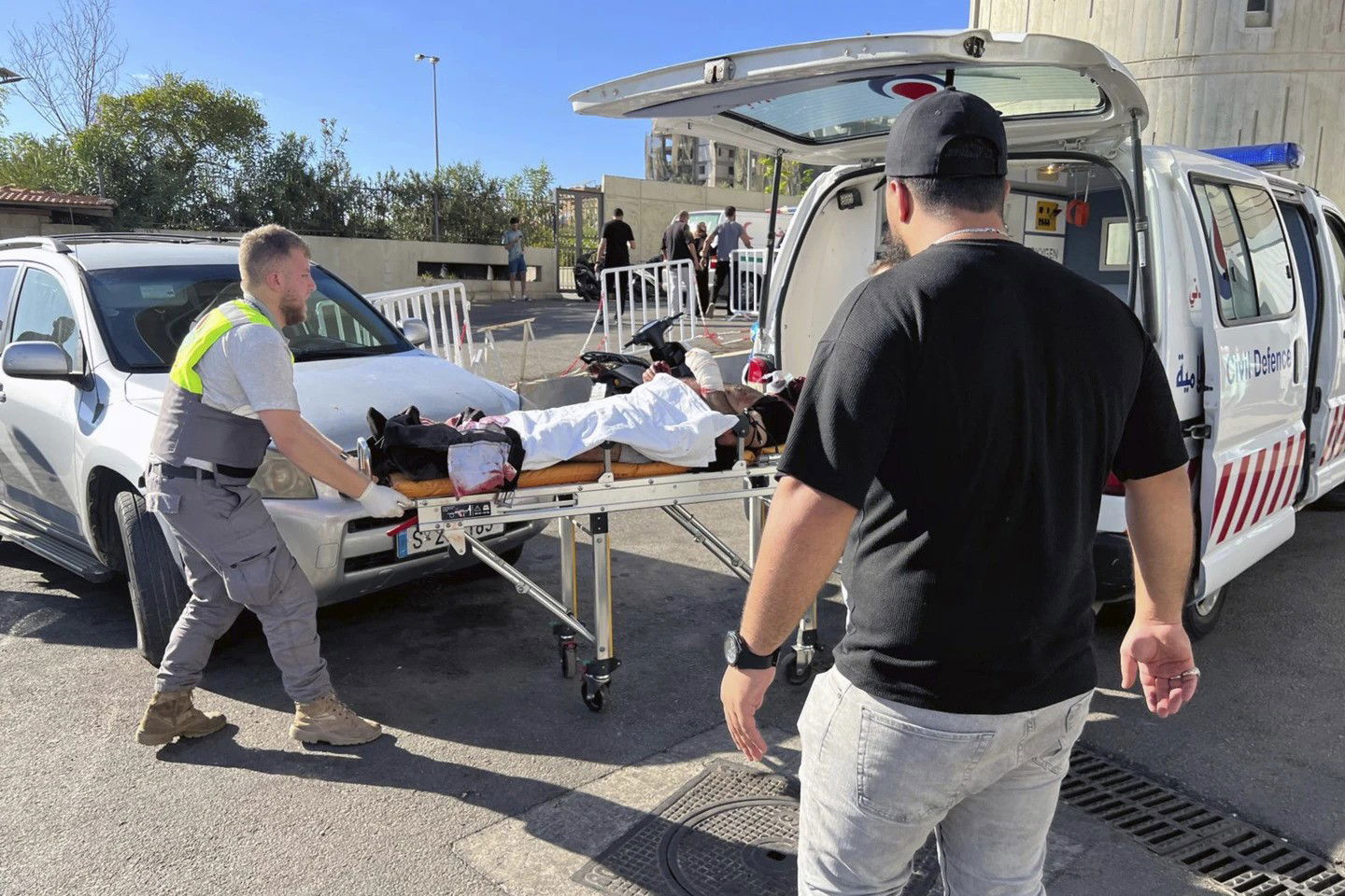 A person on a stretcher being put into an ambulance