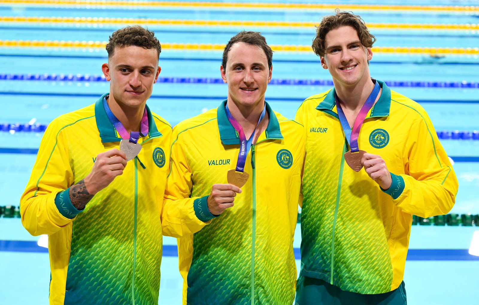 Cam McEvoy, Jamie Jack and Flynn Southam standing for a photo with their medals