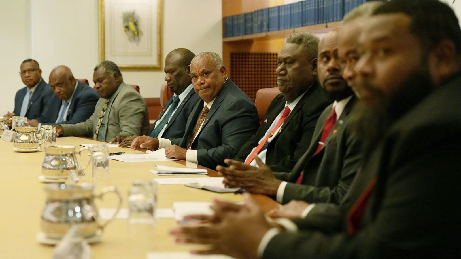 Jotham Napat sits with his delegation at the cabinet table.