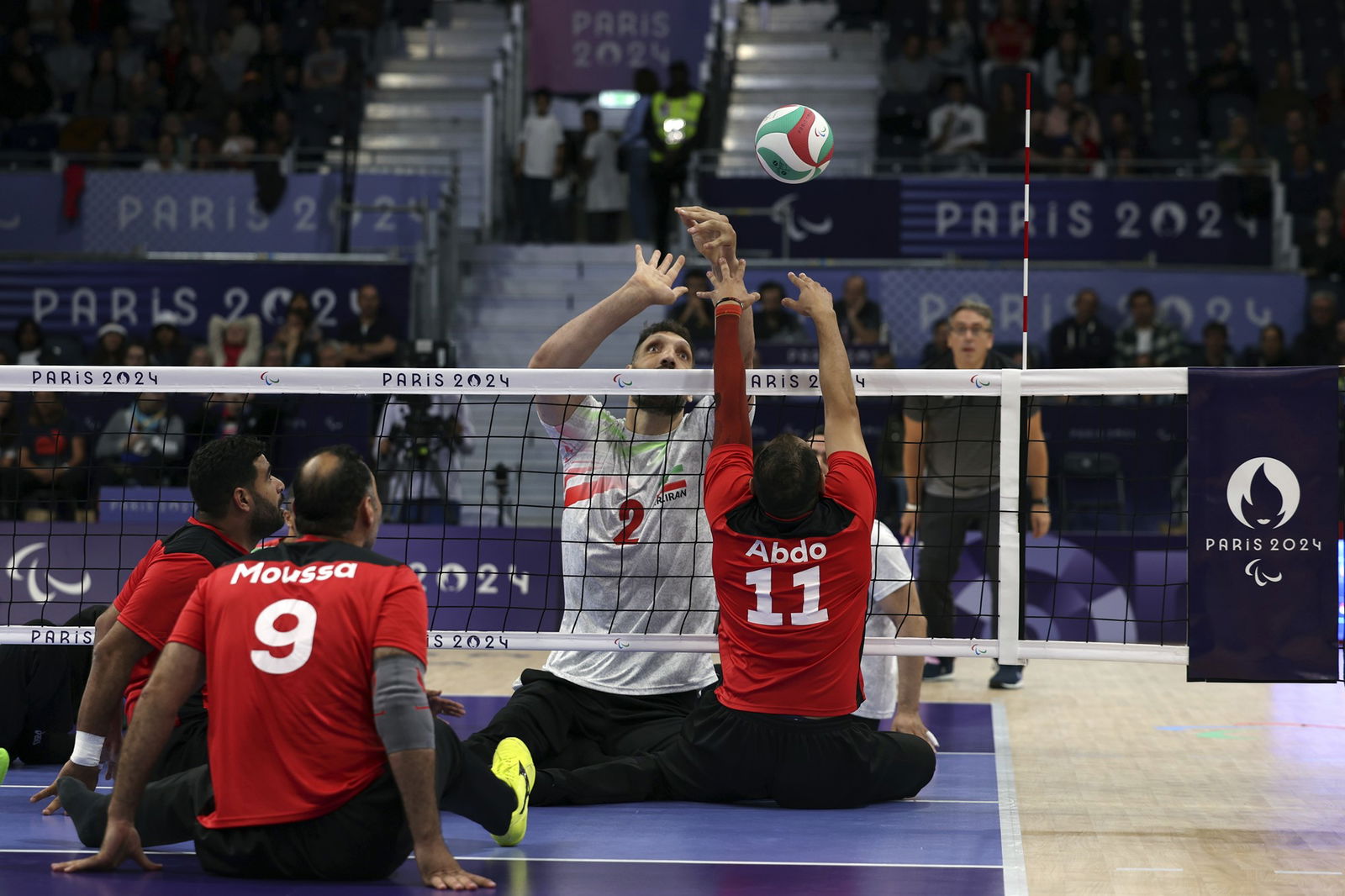 Iran's Morteza Mehrzadselakjani, number 2, attempts to block the ball from Egypt's Zakareia Abdo