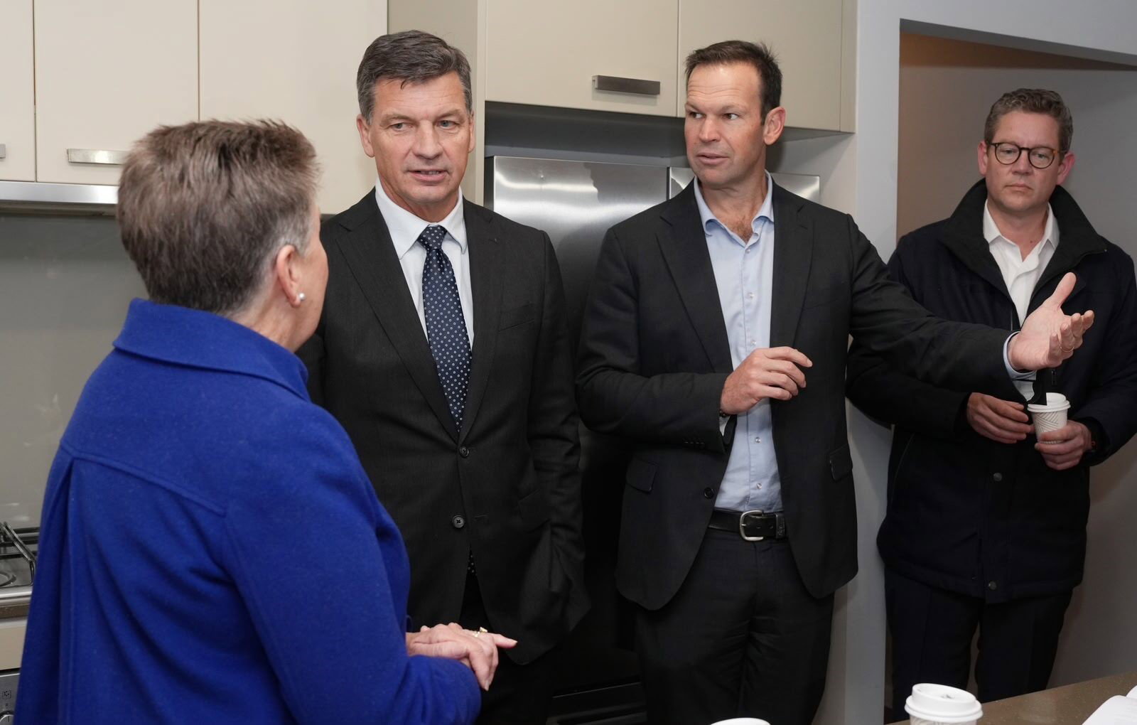 Angus Taylor and Matt Canavan speaks to a women.