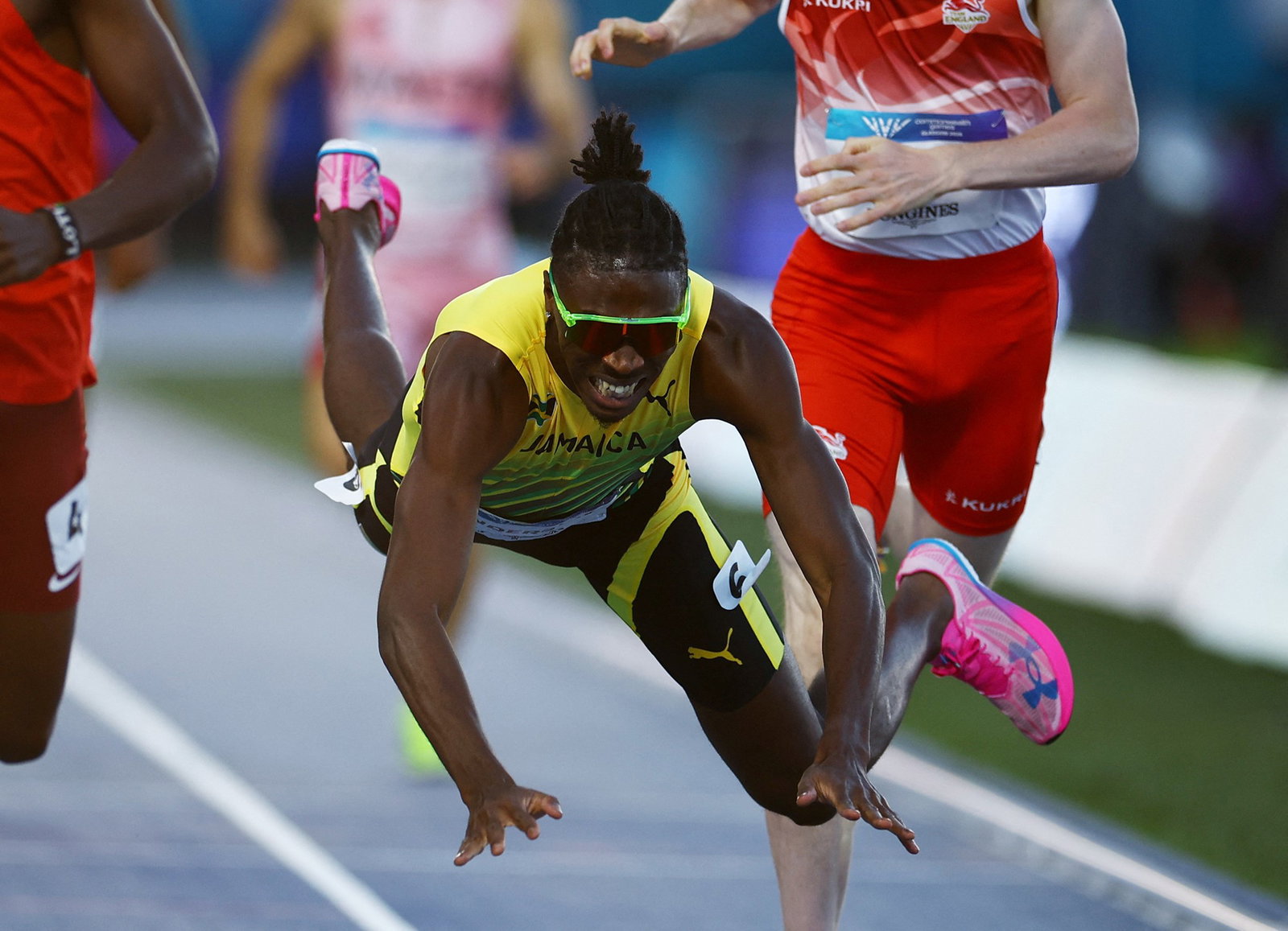 Navasky Anderson falls over finish line.