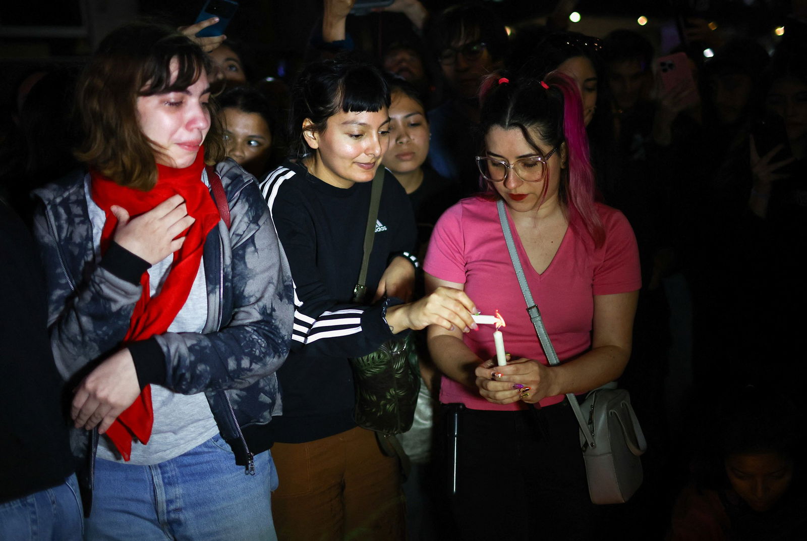 Young fans light candles