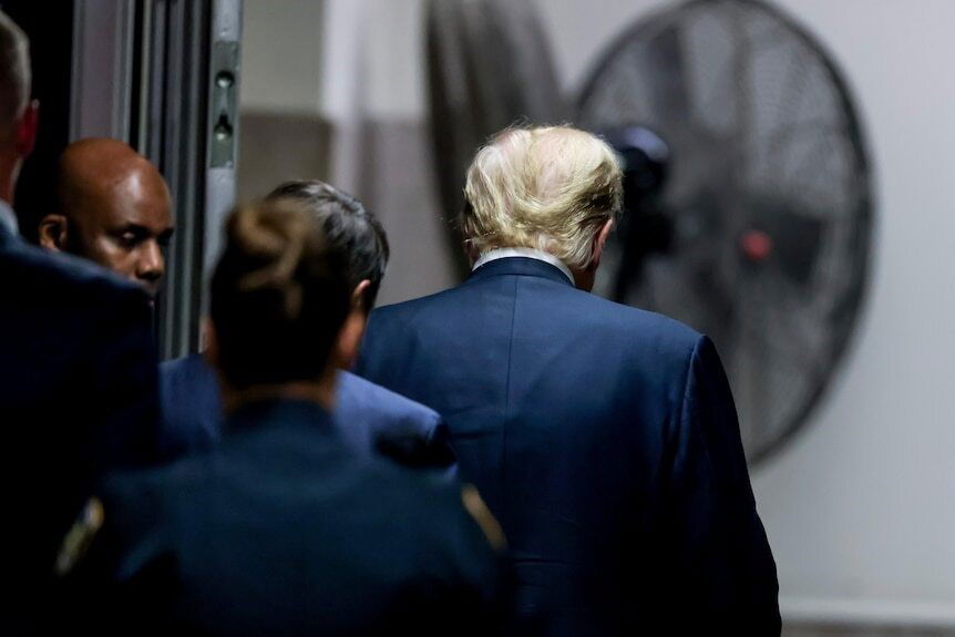 The back of Trump as he leaves court