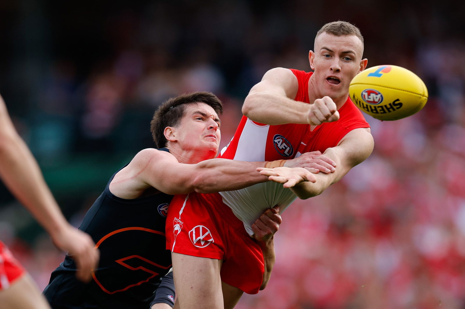 Chad Warner handballs while being tackled