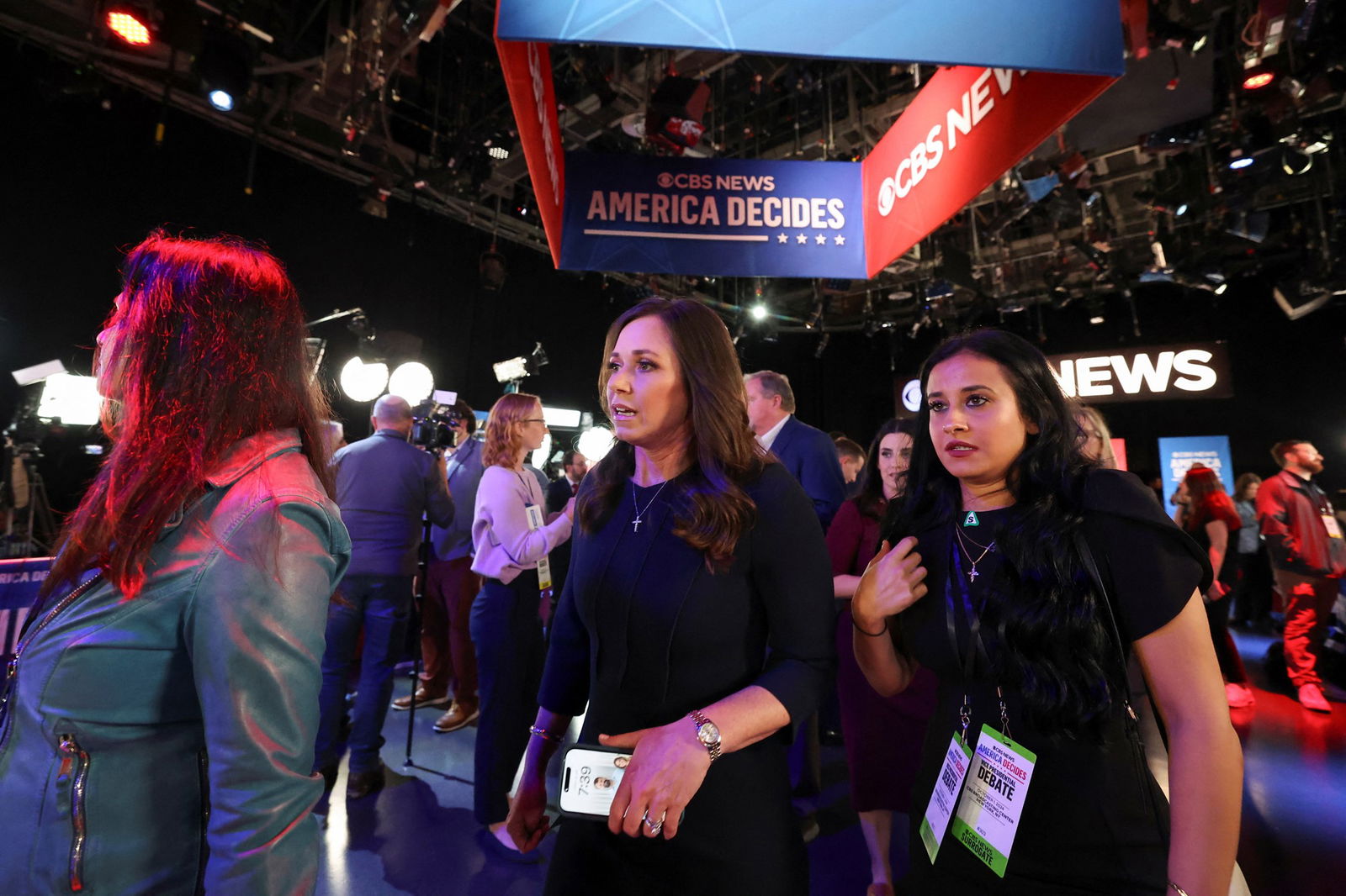 Katie Britt is flanked by assistants as she enters the spin room