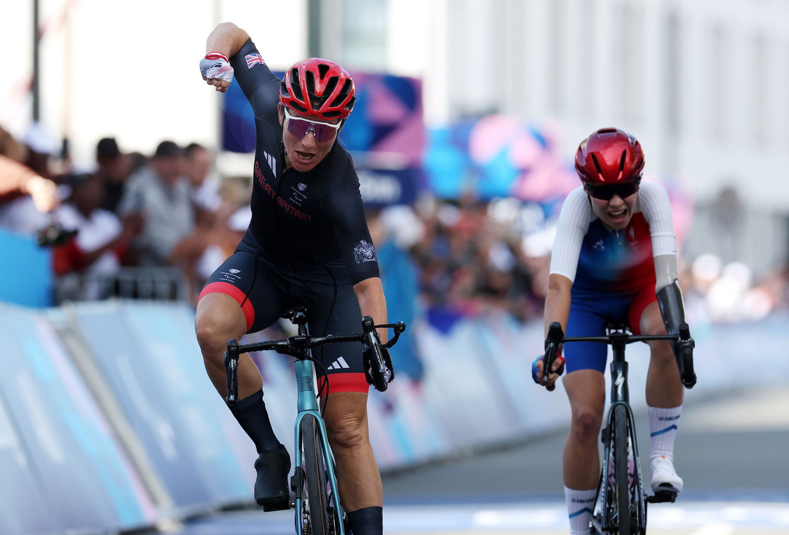 Britain's Sarah Storey and France's Heidi Gaugain celebrate gold and silver in the women's C4-5  road race in Paris.