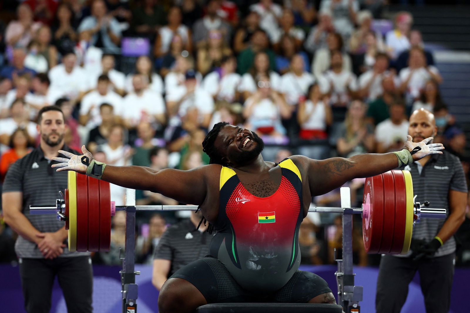 Tahiru Haruna of Ghana smiles and has his arms outstretched, gesturing happily to a crowd