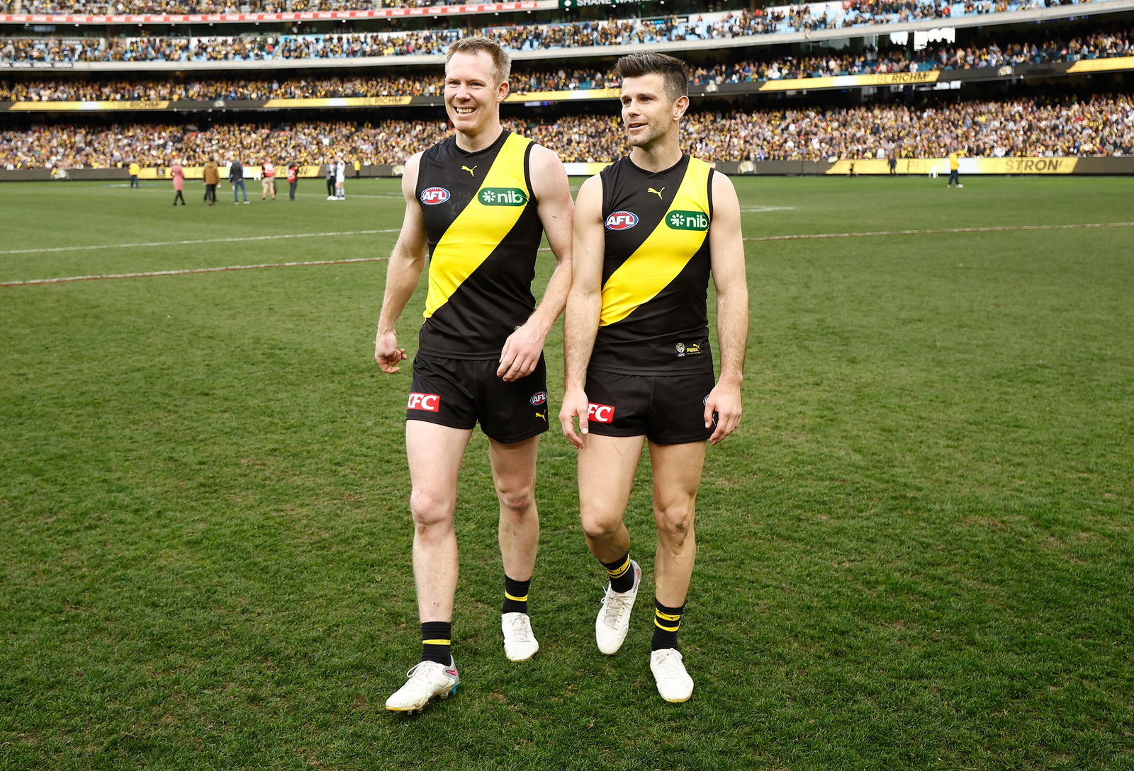 Trent Cotchin of the Tigers and Jack Riewoldt of the Tigers leave the field after their final matches during the 2023 AFL Round 23 match between the Richmond Tigers and the North Melbourne Kangaroos at Melbourne Cricket Ground on August 19, 2023 in Melbourne, Australia.