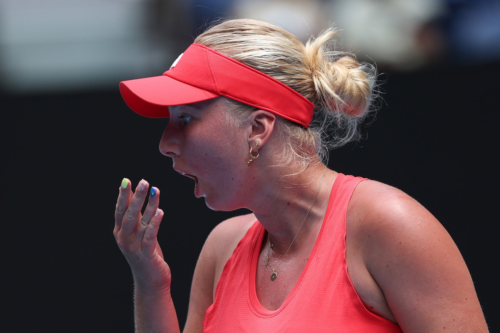 Clara Tauson puts her hand to her mouth at the Australian Open.