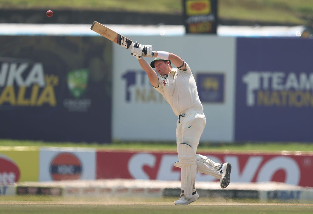 Steve Smith finishes a shot with his bat up in the air.