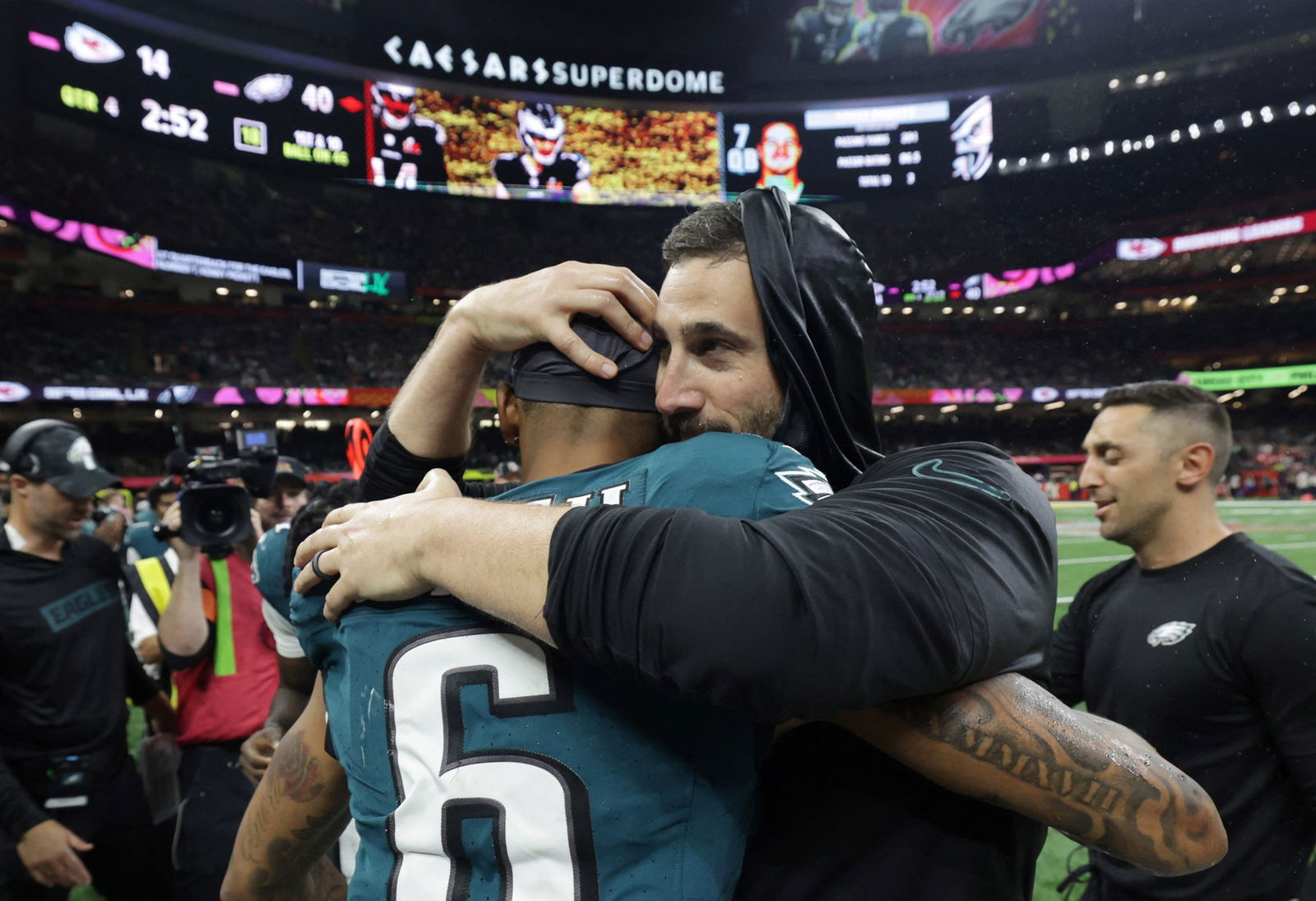 A coach hugs a player