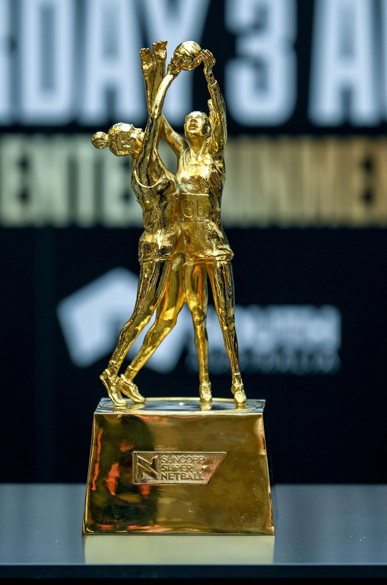 Super Netball trophy depicts two players going for the ball