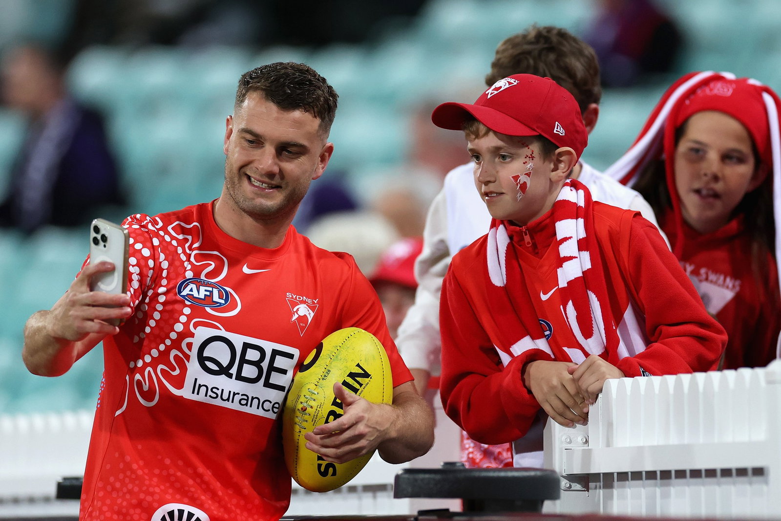 Tom Papley takes a selfie with a Swans fan.