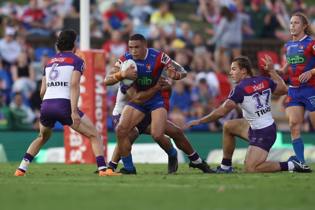 Tyson Frizell is tackled by the Melbourne Storm.