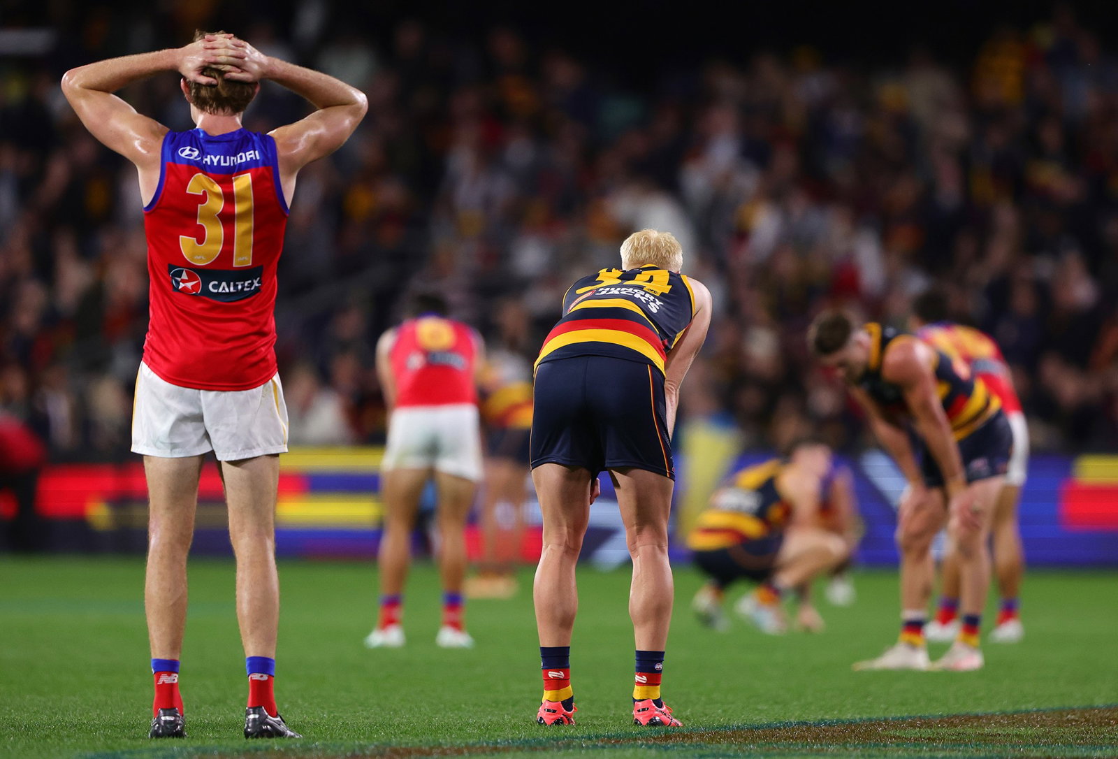 Adelaide and Brisbane players after a draw