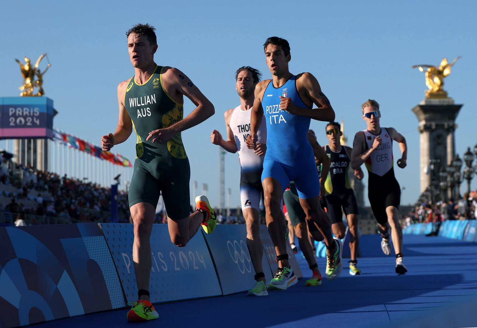 Luke Willian leads a group of runners in the mixed relay triathlon.